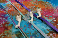Load image into Gallery viewer, the Sequins & Ribbon sewing machine presser foot with the Accessory guides showing the different size trims that they sew