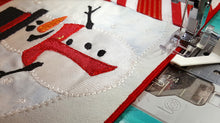 Load image into Gallery viewer, Close up of Creative Feet snowman mug rug Satinedge sewing machine foot sewing satin stitch on edge of fabric