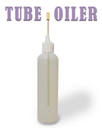 Tube oiler for  sewing machines bottle with a white cap and brass, flexible nozzle on a white background, labeled 'Tube Oiler'.